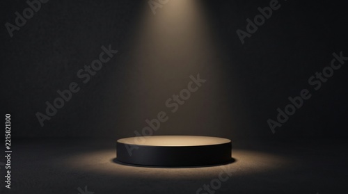 A minimalist matte black circular pedestal centered in a dark room with a soft overhead spotlight