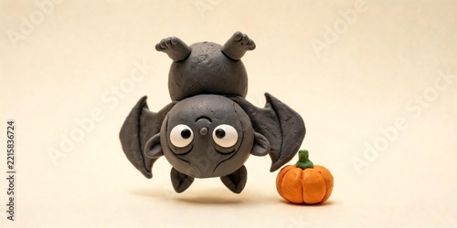Playful Clay Bat Hanging Upside Down beside a Tiny Pumpkin
