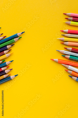 Colored pencils on a yellow background