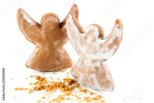 Two christmas angel cookie with crumbs on white background