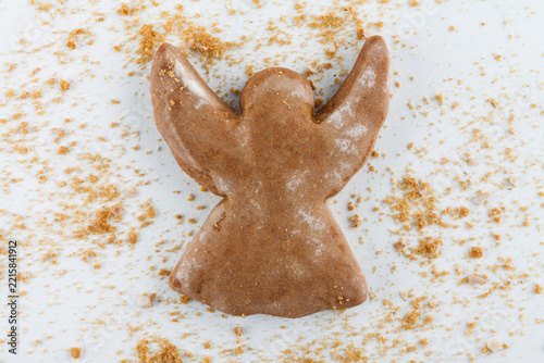 Christmas angel cookie with crumbs on white background