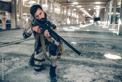 Fotografie One dark-haired man is standing in long hangar by himself