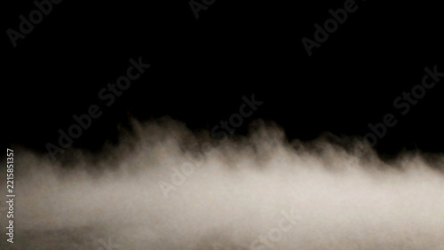 Dense low fog with warm glow across the bottom on black background