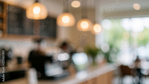 Blurred coffee shop interior background with warm hanging lights