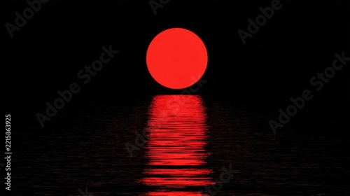 Vibrant red sun setting over a calm ocean surface creating a stunning silhouette and reflected light