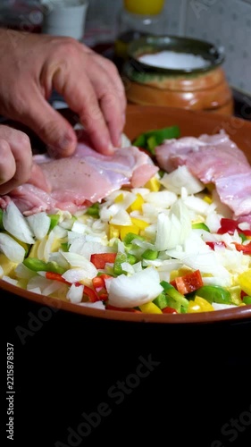 Close-up a person adds chicken legs to the pot..