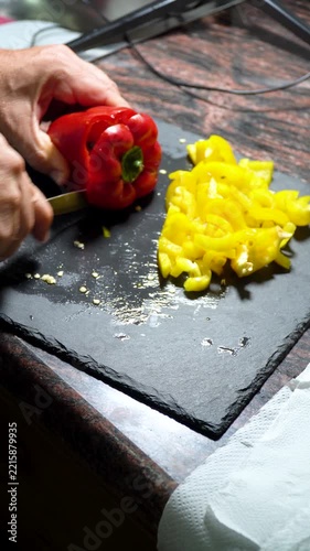 Closeup, person slicing a red pepper