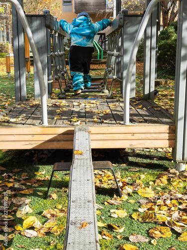 Child Enjoying Active Outdoor Play Among Autumn Leaves