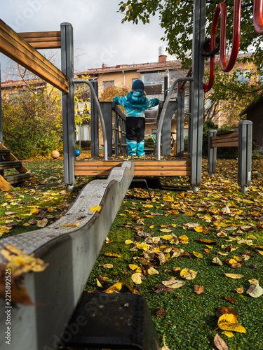 Active Toddler Playing Outdoors at Autumn Playground