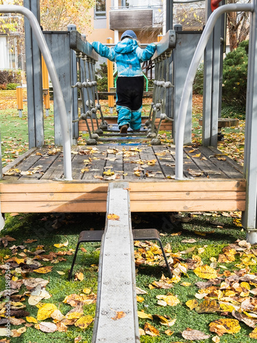 Toddler Adventure on Neighborhood Playground in Fall