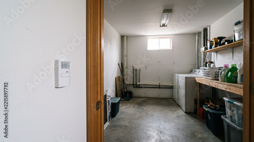 Wall motion occupancy sensor switch installed at basement laundry room entrance. Concept of motion detector, light switch, smart home, home automation, energy saving. Copy space.