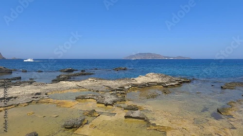 Rocky mediterranean coastline with clear water and scattered stones at Favignana island, Sicily, Italy