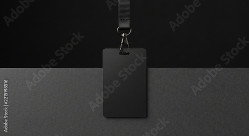 Photorealistic vertical blank black ID badge card mockup hanging with a woven lanyard against a two-tone minimalist dark background.