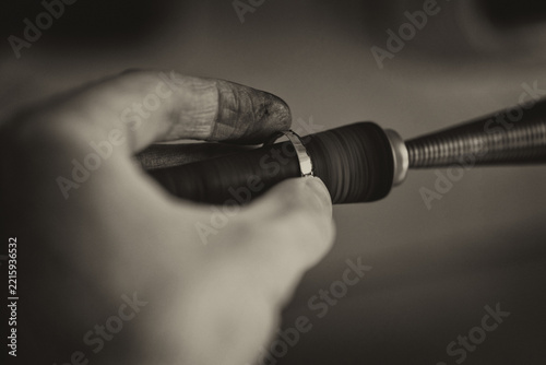 Close-Up Of Jewelry Hands Maker Using Polishing Machine