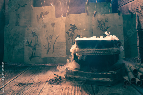 Old witch cauldron with recipe and full of scrolls.