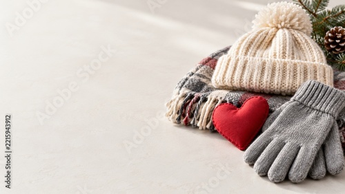 Cream Winter Hat and Gray Gloves beside a Red Heart on Ivory