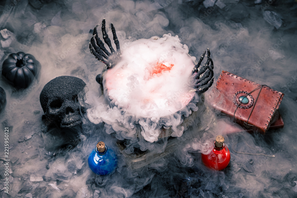 Fototapeta premium Magic potion brews inside an iron cauldron.
