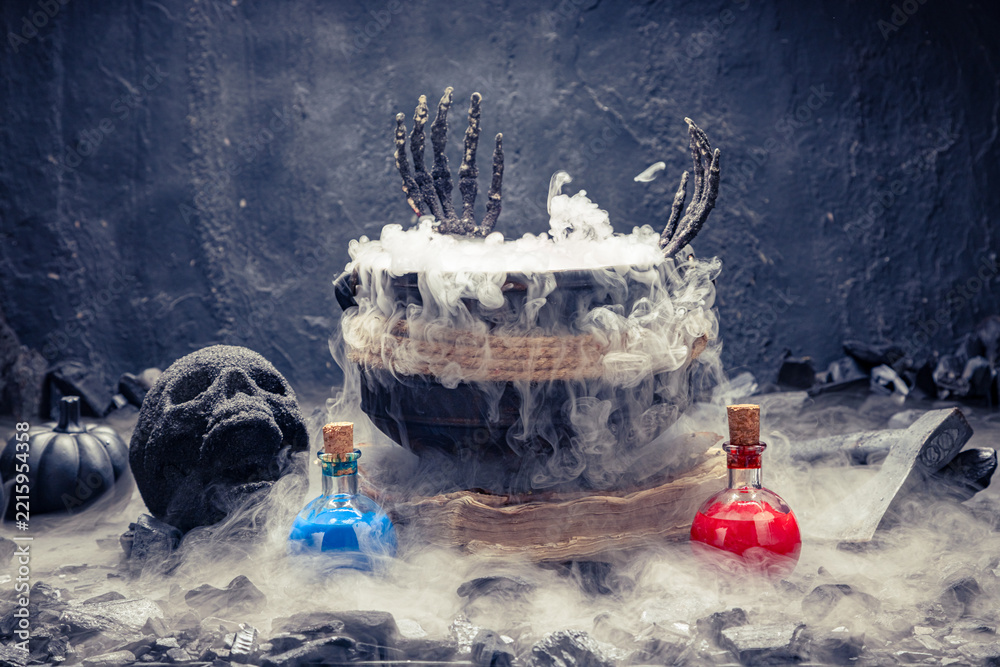 Fototapeta premium Witchcraft setup with bubbling pot and potions.
