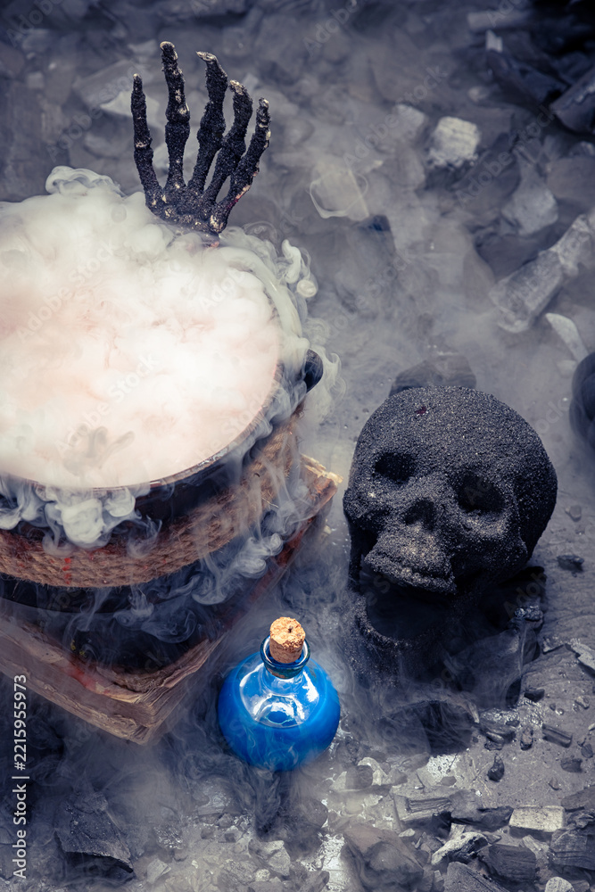 Fototapeta premium Skeletal claws rise from a cauldron vessel.