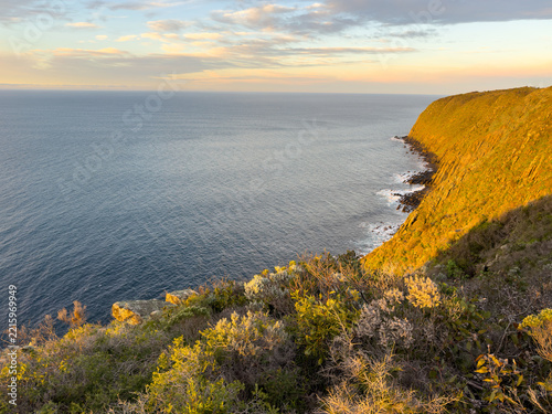 Epic sunrise golden light on the Waitpinga Cliffs at dawn over the ocean and horizon on the Fleurieu Peninsula in South Australia