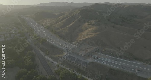 Hazy aerial view of freeway and overpass crossing in hill valley