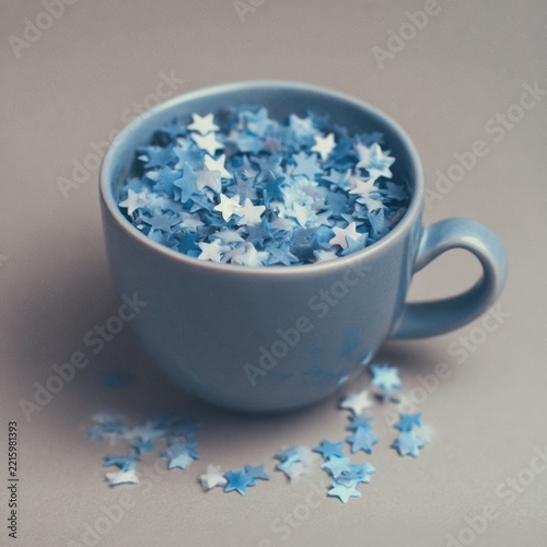Blue cup filled with tiny star shapes