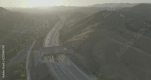 Aerial view of freeway with overpass bridge in hazy hills