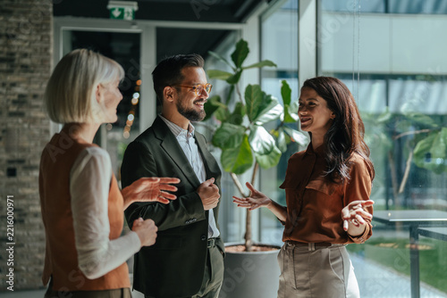 Business colleagues collaborating and discussing ideas in modern office