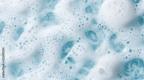 White foam bubbles over pale blue water