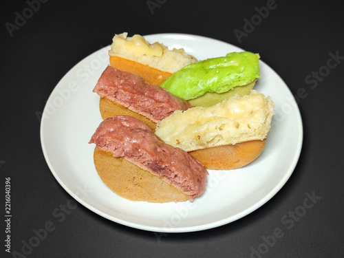 Pukis, Indonesian Traditional Dessert Food Served on a White Plate with Dark Background. 