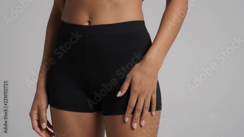 Elegant Woman in Black Athleisure Outfit Posing Confidently | Studio Portrait