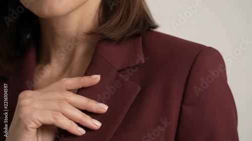 Elegant Woman in Maroon Blazer Adjusting Collar - Professional Business Portrait