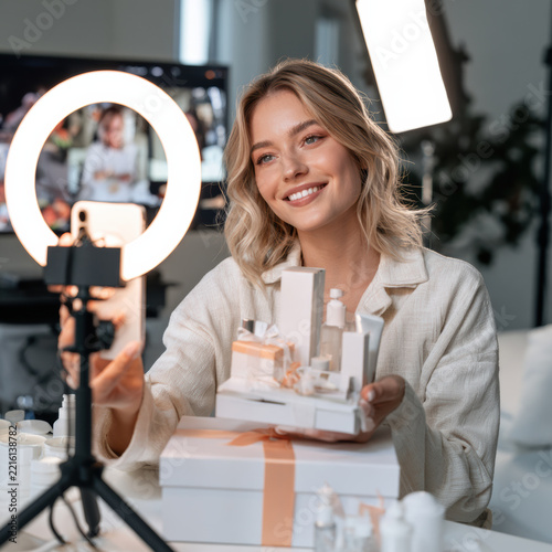 Woman holding skincare product for ecommerce promotion with warm smile and studio lighting