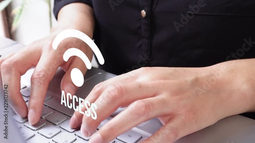 Person types on laptop with wireless access graphic