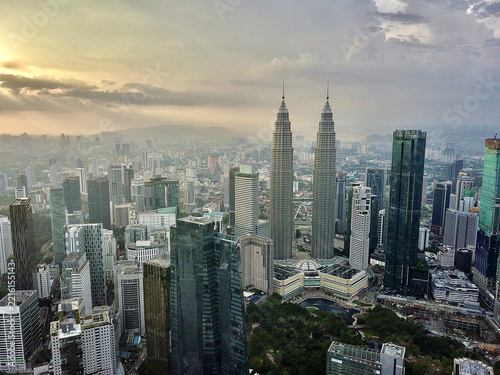 Photography Aerial view of Petronas Twin Towers at dusk in Kuala Lumpur, Malaysia, symbolizi