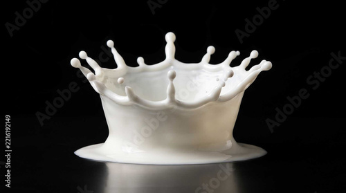 High speed photography of a white milk splash forming a perfect crown shape isolated on a black background
