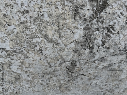 Weathered white and gray concrete wall texture with cracked, peeling, and distressed surface details. Neutral aged background suitable for architectural, industrial, grunge, vintage, and abstract