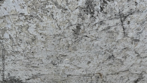 Weathered white and gray concrete wall texture with cracked, peeling, and distressed surface details. Neutral aged background suitable for architectural, industrial, grunge, vintage, and abstract