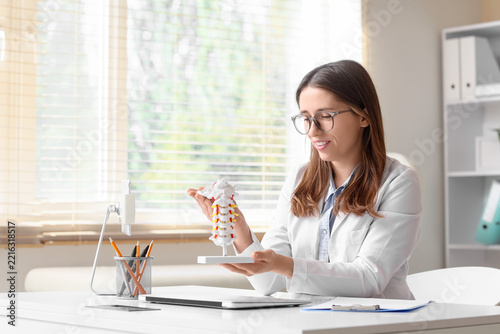 Chiropractic care and spinal health, doctor explaining cervical spine anatomy...