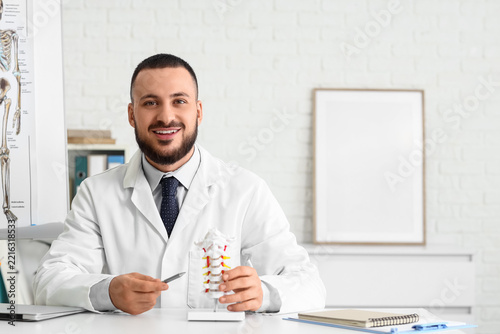 Chiropractic care and spinal health, male doctor explaining cervical spine an...
