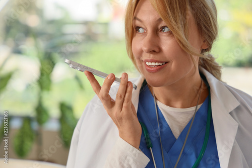 Telemedicine and remote healthcare, doctor using smartphone for voice message...