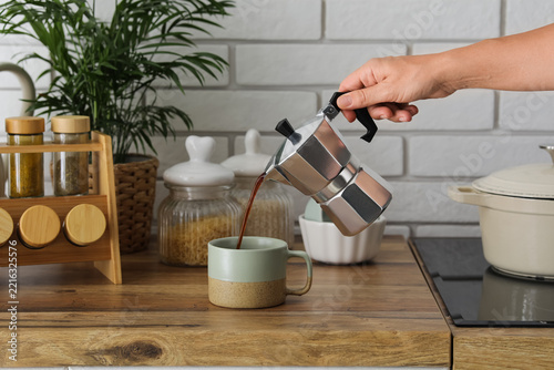 Fotografie Morning coffee routine and home lifestyle, person pouring fresh espresso from a