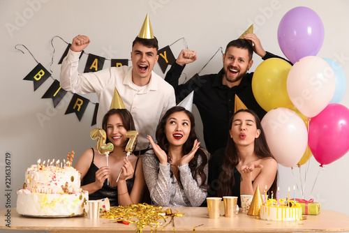 Birthday celebration and party fun, group of diverse friends cheering with ca...