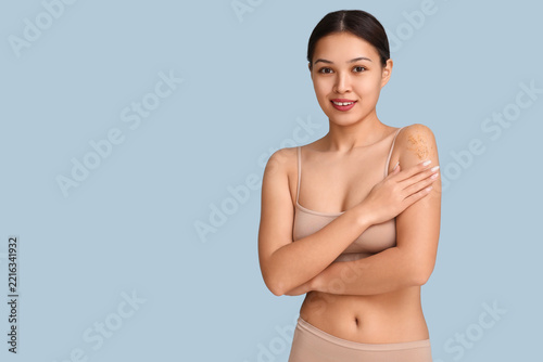 Skincare and body care routine, young woman applying exfoliating scrub on sho...