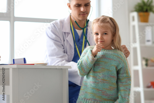 Pediatric healthcare and medical checkup, doctor examining a young girl with ...