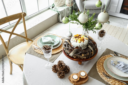Festive table setting for Christmas dinner in modern living room