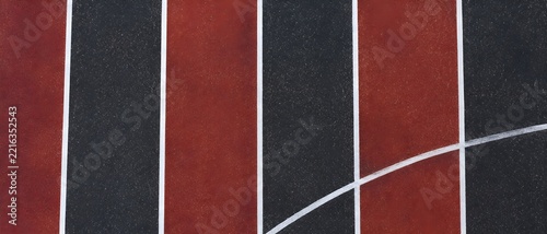 Straight white lane markings on a synthetic sports running track