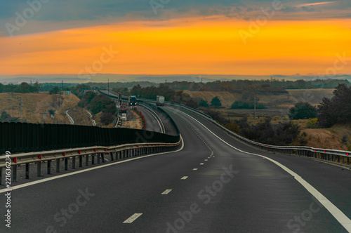 Trucks on highway at lovely morning sun