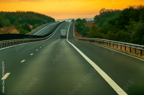 Trucks on highway at lovely morning sun