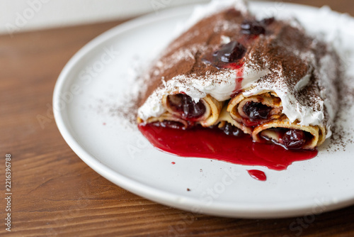 Traditional Moldovan layered dessert Căciula lui Guguță with sour cherries and cream 
